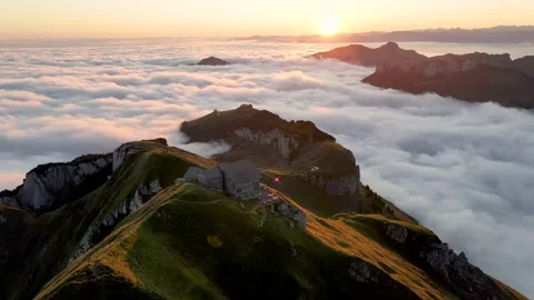 Aerial view of sun rising over cloud sea and lodge Stock Footage 301244553