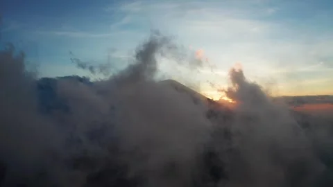 Aerial View Of Sun Setting Behind Dark Stormy Clouds And Hill Stock Footage 333604300
