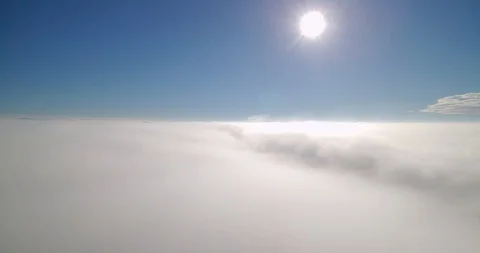 Aerial view of sun shining on a blue sky above clouds Stock Footage 99898438