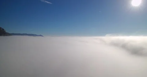 Aerial view of sun shining on a blue sky above clouds Stock Footage 100515974