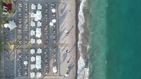 Aerial view of sunbathing people at the beach by turquoise sea Video stock 344729662