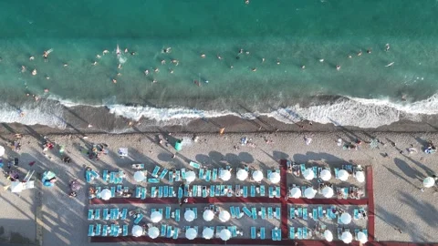 Aerial view of sunbathing people at the beach Stock Footage 344729841