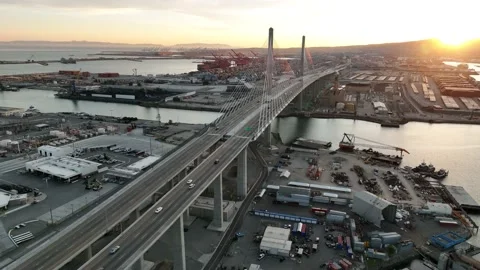 Aerial view at sunet over freeway, bridge and shipyard containers Stock Footage 171835421