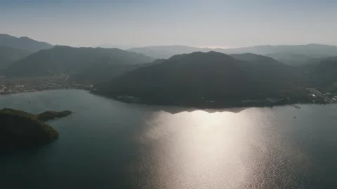 Aerial View of Sunlit Bay Surrounded by Mountains Stock Footage 282931110
