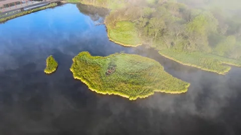 Aerial View of Sunlit Central Green Island Lake Surface in Shennongjia Hubei Stock Footage 337938536
