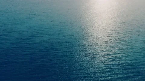 Aerial view of the sunny path on the surface of the ocean at sunset Video stock 238597495