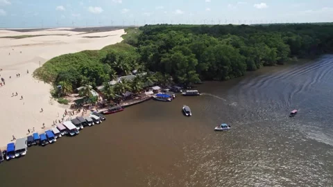 Aerial view of sunny river bank and dune - Barreirinhas, Brazil Stock Footage 331517341