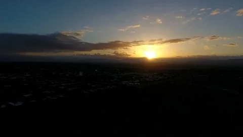 Aerial view of a sunrise over a small town Stock Footage 75675355