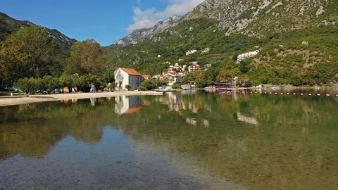 Aerial view of sun's rays is reflected in quiet surface of mountain lake Stock Footage 117573013