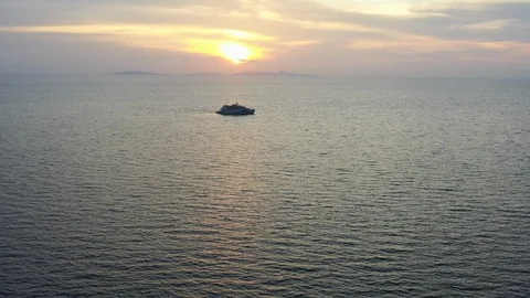 Aerial View of Sunset and Small Ship in Tropical Pacific Ocean Video stock 127728039