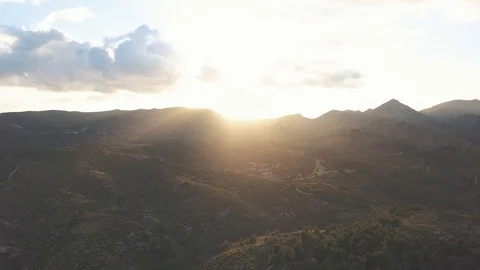 Aerial view of sunset behind large mountains in mallorca Stock Footage 101564734