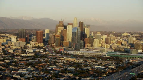Aerial view at sunset of evening commuters on busy LA freeways Video stock 64789761