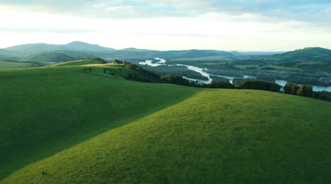 Aerial View. Sunset. Flight over a green grassy rocky hills. Stock Footage 35218551