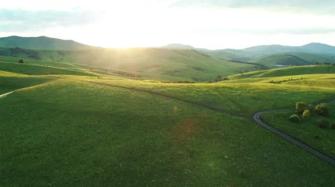 Aerial View. Sunset. Flight over a green grassy rocky hills. Stock Footage 35218637
