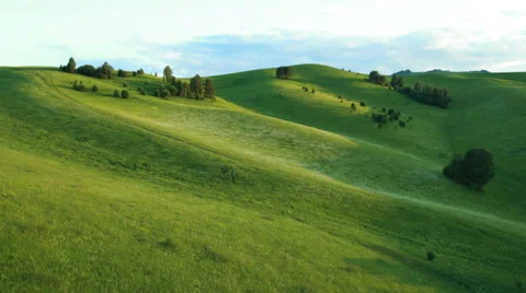 Aerial View. Sunset. Flight over a green grassy rocky hills. Stock Footage 35218915