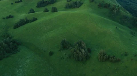 Aerial View. Sunset. Flight over a green grassy rocky hills. Stock Footage 35219765