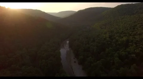 Aerial view of a sunset , flying over the green canyon , lens flare 4k Stock Footage 65235475
