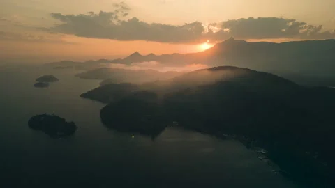 Aerial View Into The Sunset, of Islands Backlit Clouds, 4k Stock Footage 239686656