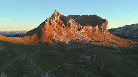 Aerial view - sunset light on a mountain peak Stock Footage 232273437