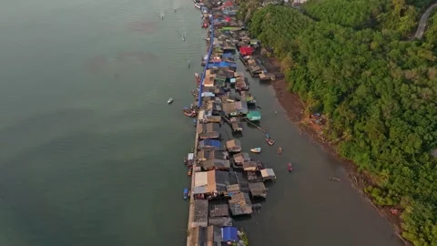 Aerial view of sunset light on stilt houses at Ao Salat, Koh Kood, Thailand Stock Footage 310523631
