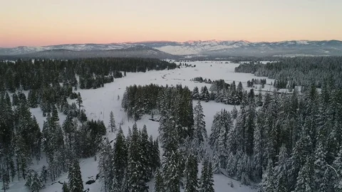 Aerial View of Sunset on Mt Rose over a snowy field Stock Footage 71702332