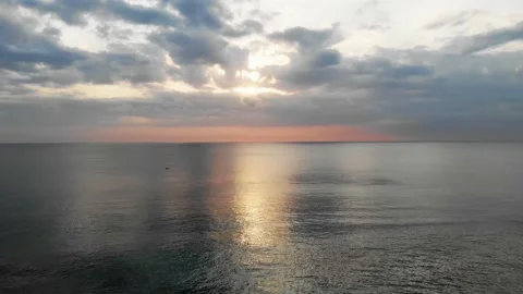Aerial view of sunset ocean and lonely fisherman Stock Footage 147547550