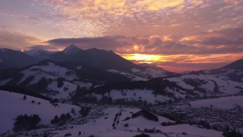Aerial view of sunset, Orange clouds , winter rural landscape in mountains Stock-Footage 233632499