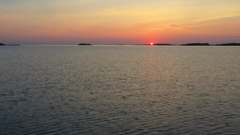 Aerial view of a sunset over a calm sea Video stock 124385776