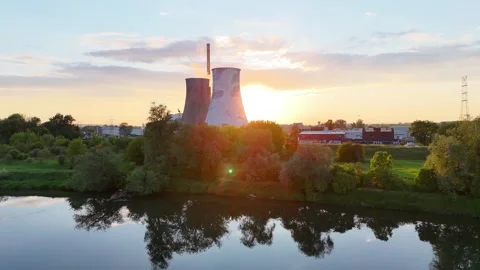 Aerial view of sunset over calm river reflecting clouds and industrial buildings Видео 335478440