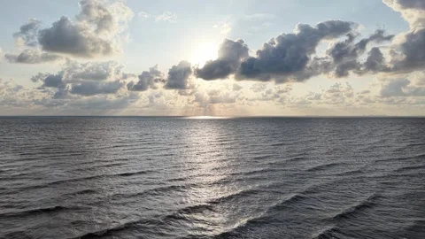 Aerial view of sunset over calm ocean waters Video stock 337538105