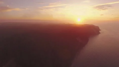 Aerial view of a sunset over the cliff at the sea Stock Footage 253472149