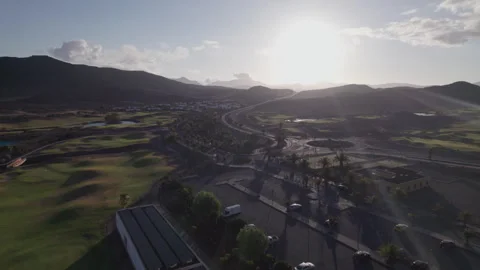 Aerial view of sunset over golf field and parking area, Fuerteventura Stock Footage 310406834