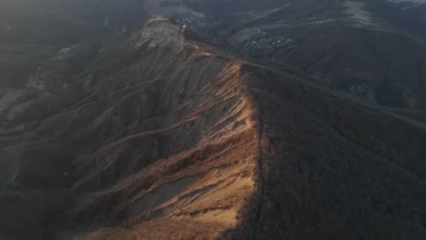 Aerial view of Sunset over a mountaintop chape Video stock 272251876
