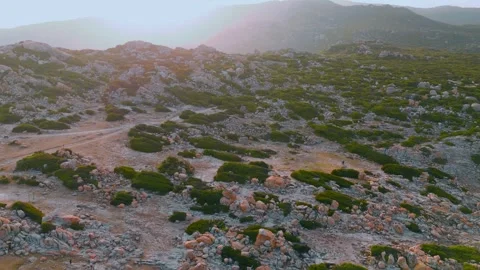 Aerial View: Sunset Over Rugged Rocky Landscape and Misty Mountains Stock-Footage 340464175