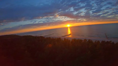 Aerial view of sunset over sandy big beach with forest Stock Footage 118537690