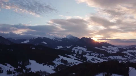 Aerial view sunset over winter mountain trees landscape, colored clouds at dusk 스톡 동영상 170780897