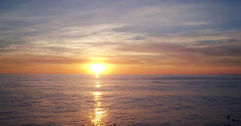 Aerial View Sunset into Pacific Ocean. Flying Low Over Water Stock Footage