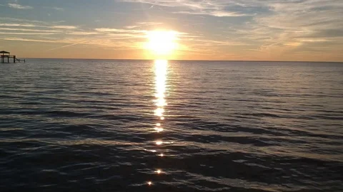 Aerial View of Sunset Reflected Over the Sea - Near Water Stock Footage 129252055