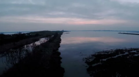 Aerial view of sunset reflection on lake in Italy Stock Footage 47947555