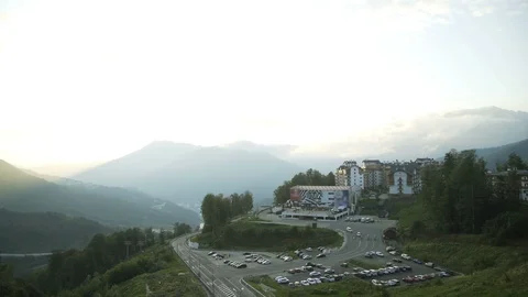 Aerial view at sunset in Rosa Khutor ski resort plateau, buildings and car 스톡 동영상 116671630