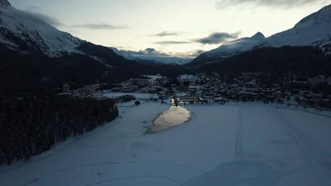 Aerial view of sunset in Saint Moritz in Winter with the Alps in the background. Stock Footage 295883394