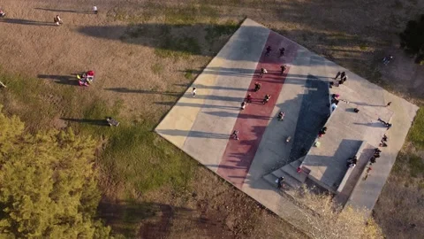 Aerial view at sunset of tango couples dancing outdoors in a class in the Stock Footage 211658436