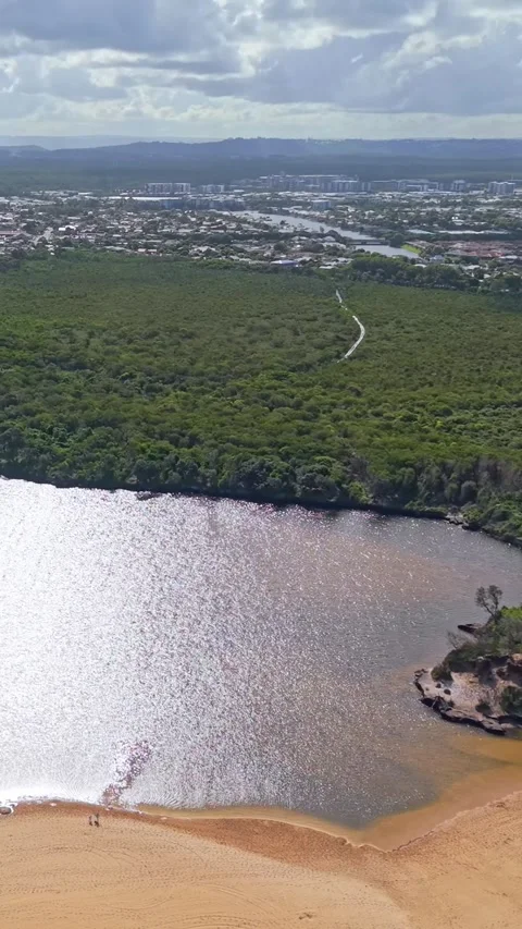 Aerial view of Sunshine Coast river estuary and wetlands with suburban skylin Video stock 334785201