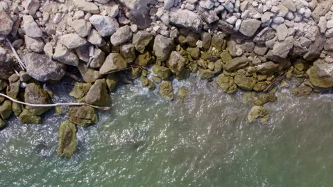 Aerial view of the surf on small rocks Stock Footage 282311012