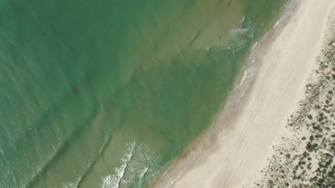 Aerial view of a surface of the ocean coastline on a sunny summer day. Stock Footage 225486804