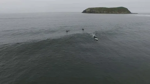 Aerial View Of Surfer Catching A Wave While Friends Watch Stock Footage 70401219