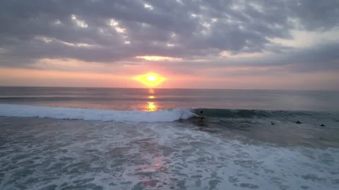 Aerial View of Surfer Catching a Wave During Sunset, 4K Stock Footage 144598221