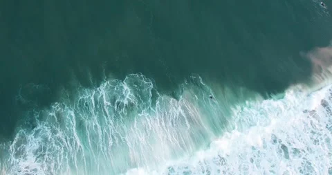 Aerial view of a surfer filtering a wave. 動画素材 261591891