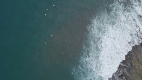 Aerial view of surfer rides on waves in the ocean Video stock 113664239