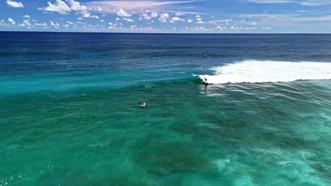 Aerial view of a surfer riding a wave in Indonesia. Stock Footage 340657006